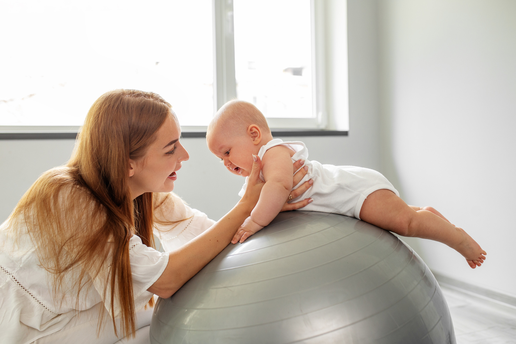 Stability ball exercises for neurodevelopment of baby. Low muscle ball. Tummy time.